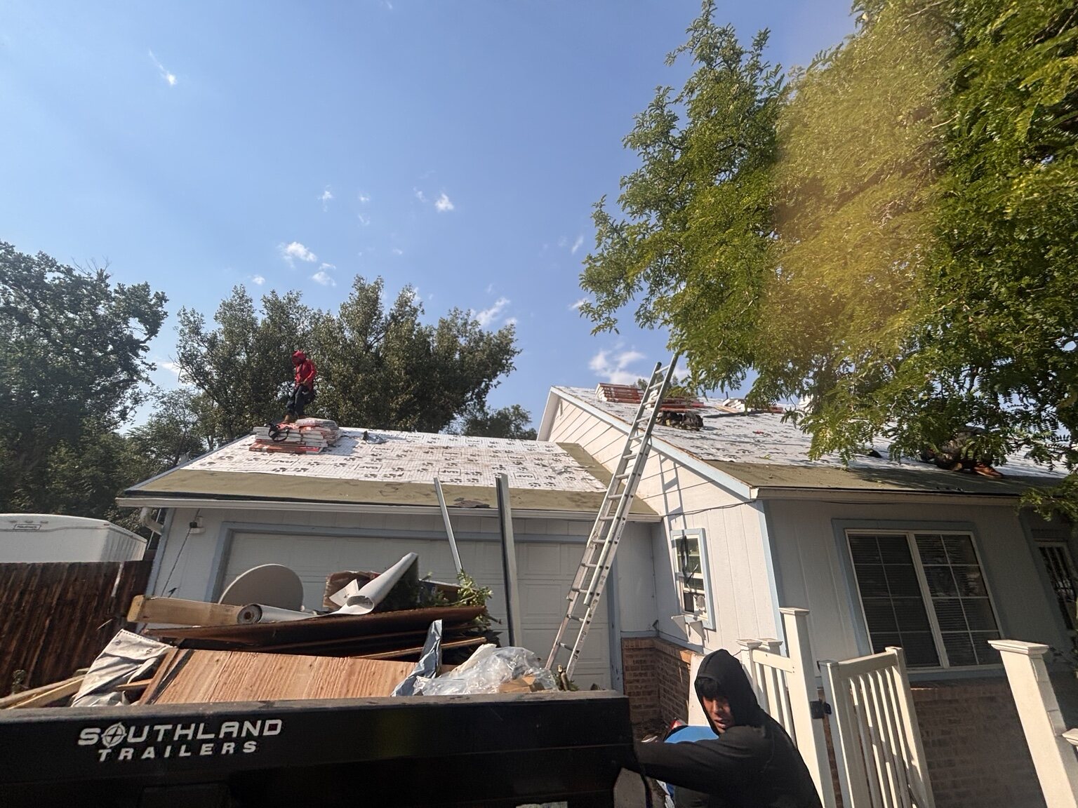 Roof replacement preparation with crew and materials
