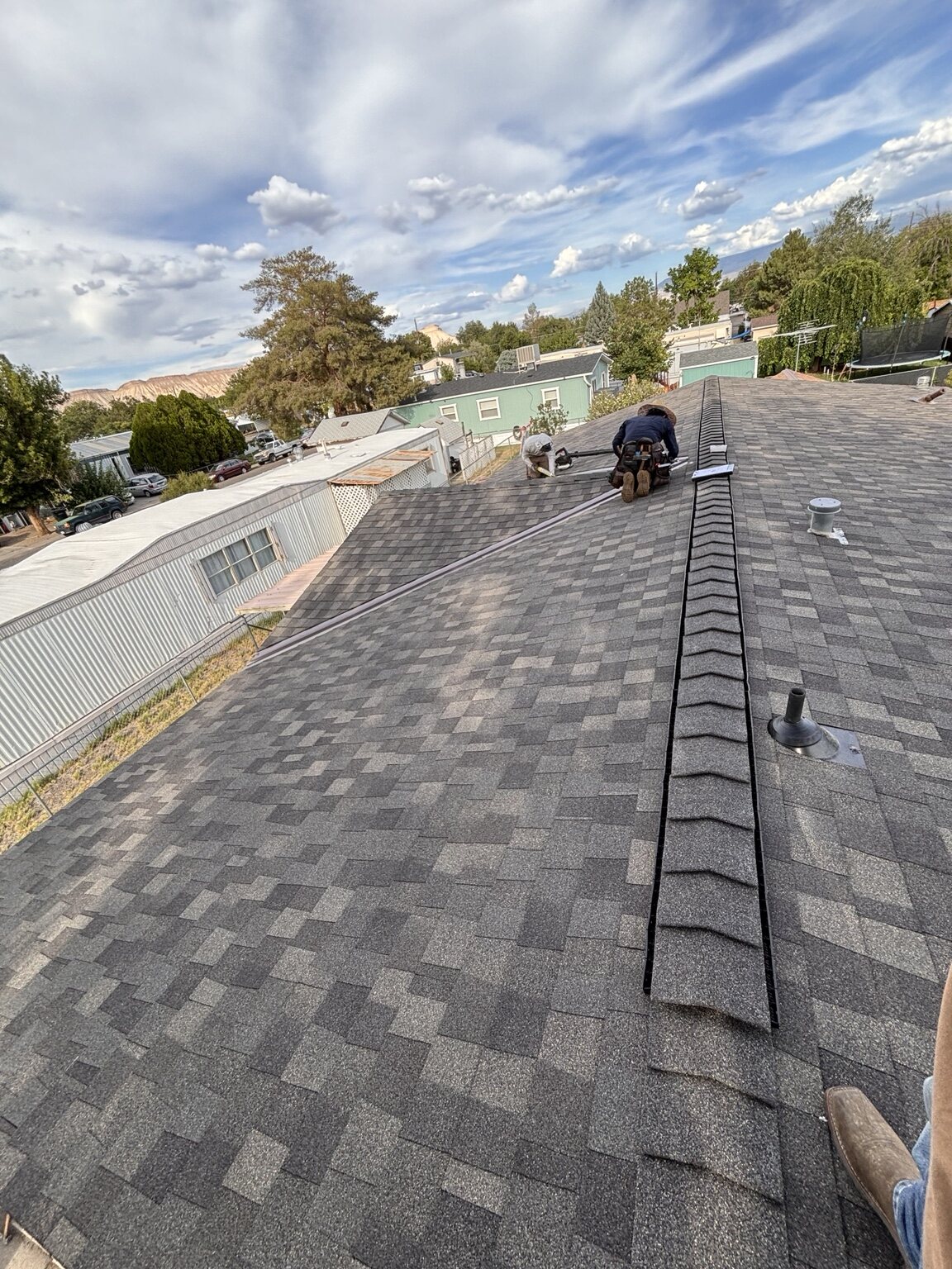 Crew completing ridge-cap installation