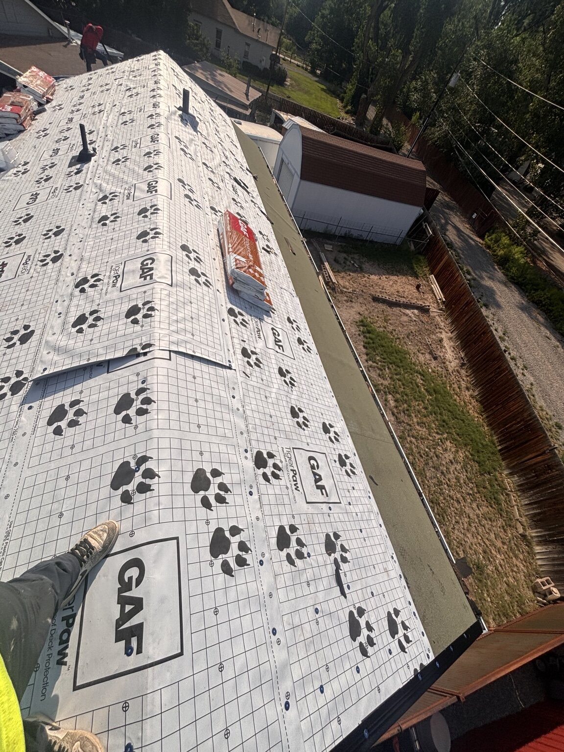 Synthetic roof underlayment installed across roof deck